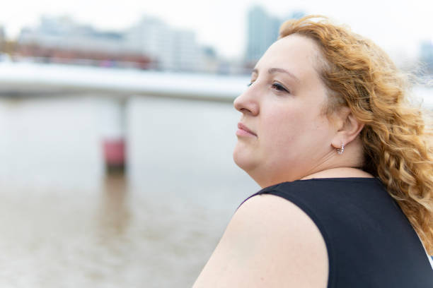 Plus size blonde woman posing on the waterfront