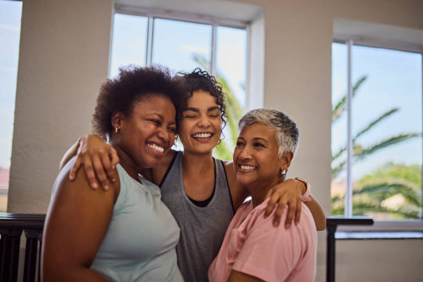 istock Young female coach hugging diverse students and smiling cheerfully together in studio 2159279000