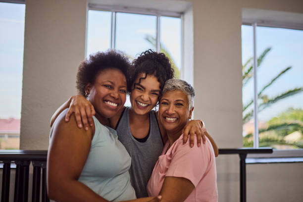 istock Young female coach hugging multiethnic students, smiling cheerfully together at camera in studio 2159279010