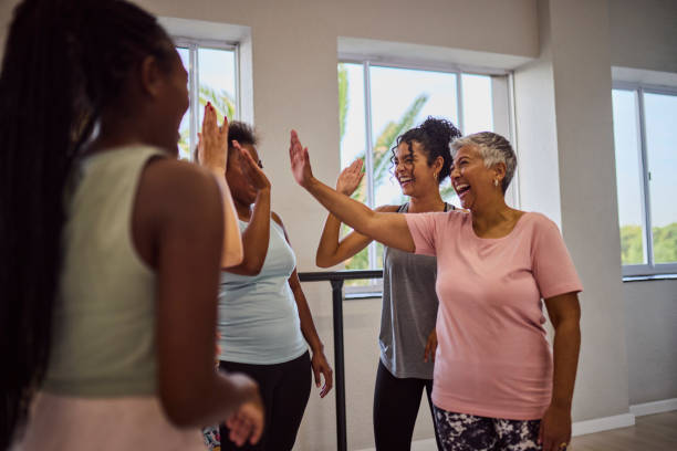 istock Excited group of multiethnic girlfriends doing high five with coach after class in studio 2159279014