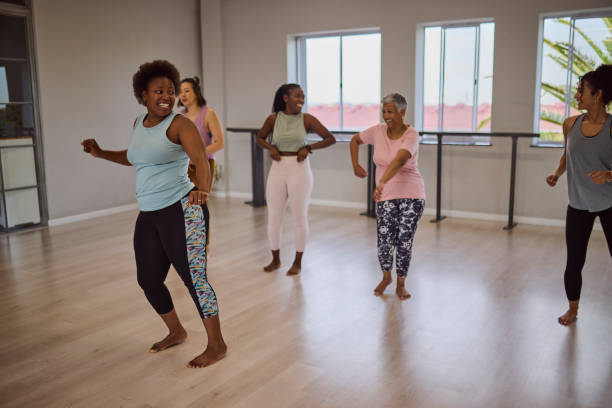 istock Group of multiethnic students and coach having fun dancing after yoga class in studio 2159279022