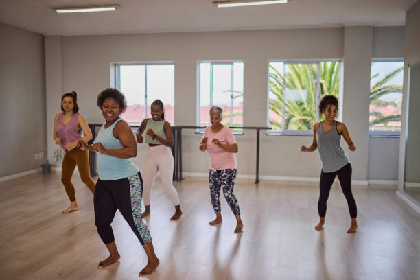 istock Cheerful female coach and multiethnic students enjoying dancing after yoga class in studio 2159279024