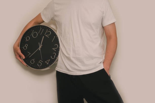 time management business planning concept, Man holding clock on white background