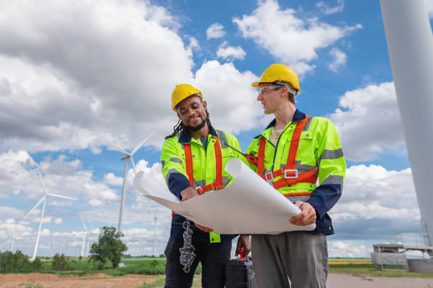 istock Two men in safety gear are looking at a blueprint 2159286257
