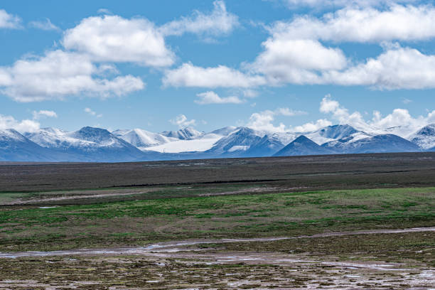 istock Cloudy weather, snow-capped mountains and meadows on the plateau 2159289006