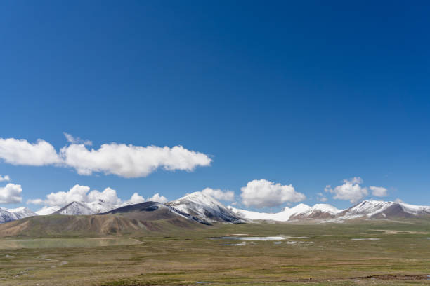 istock Plateau meadow and snow-capped mountains on a sunny day 2159289031
