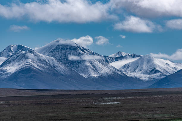 istock Cloudy weather, snow-capped mountains and meadows on the plateau 2159289058