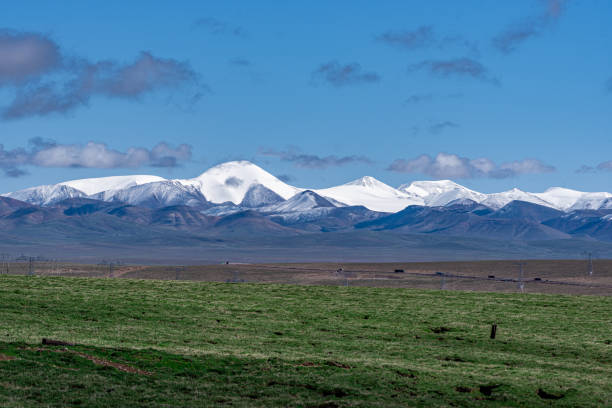 istock Cloudy weather, snow-capped mountains and meadows on the plateau 2159289084
