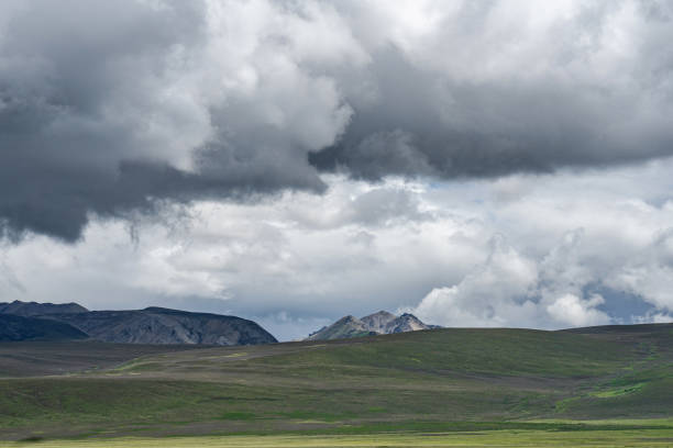 istock Cloudy sky, mountains on the plateau, green land 2159289382