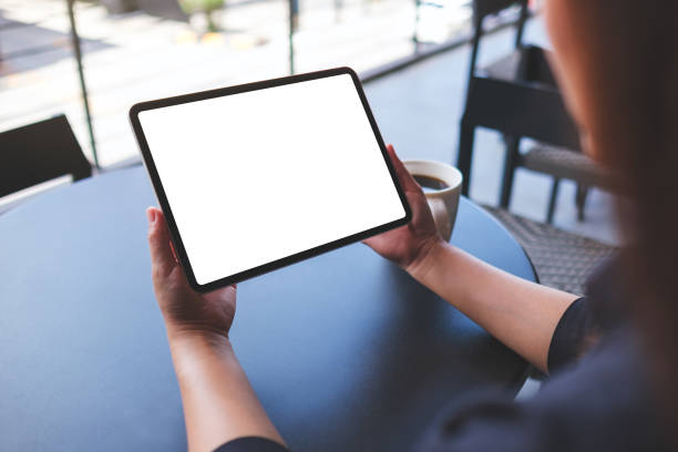 istock Mockup image of a woman holding digital tablet with blank white desktop screen in cafe 2159289637