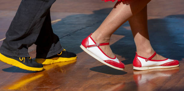 details of dancers feet on the parquet of the dance class
