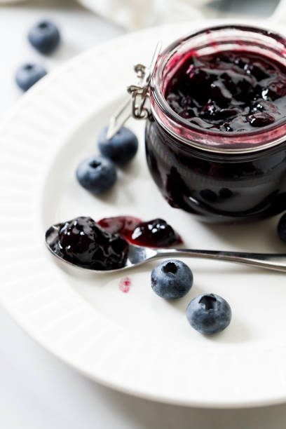 istock Blueberry jam with fresh berries on white marble table background. Selective focus. 2159292942