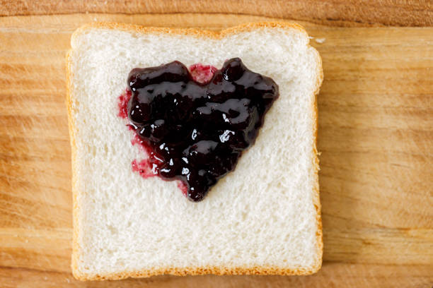 istock Heart shape blueberry jam with fresh berries on bread on rustic wooden table background. Selective focus. 2159293001