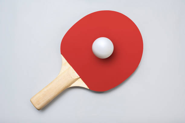 Ping pong racket with the ball for playing table tennis on a colored background