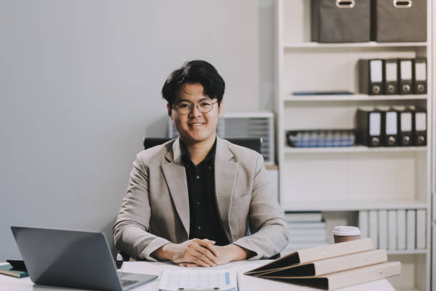 istock Video call online meeting asian businessman looking web camera and having fun talking and gesturing, man working inside office sharing plans with partners and colleagues, boss in shirt and glasses. 2159294309