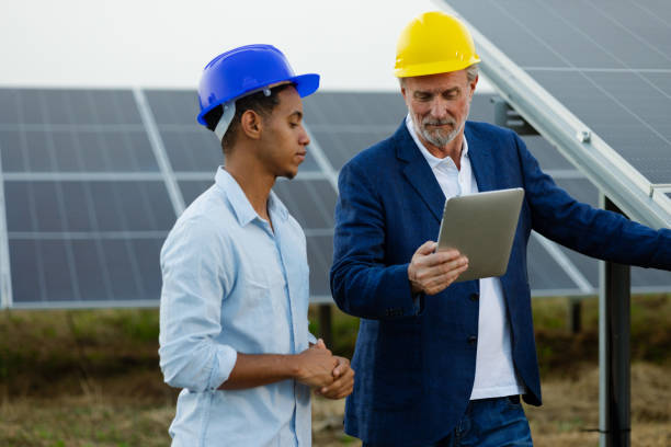 istock Two engineers overseeing the work of the solar energy system 2159295013