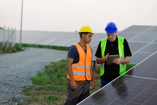 istock Two engineers engaged in work at the solar farm 2159295022