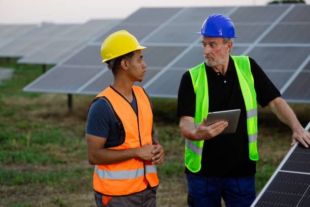 istock Engineer and his new colleague cooperating at the solar power site 2159295026