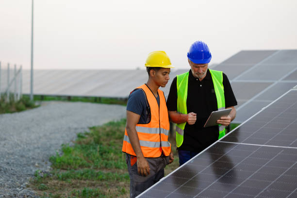 istock Senior engineer and his fresh-faced colleague working together at the solar installation 2159295028