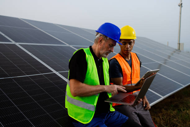 istock Experienced engineer and his young colleague collaborating at the solar facility 2159295051