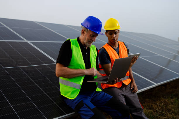 istock Experienced engineer and his young colleague working at the solar plant 2159295055