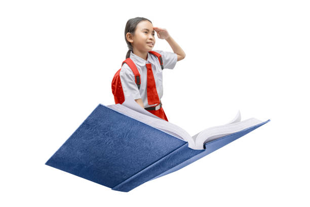 Smiling school girl looking into the distance while riding a flying book