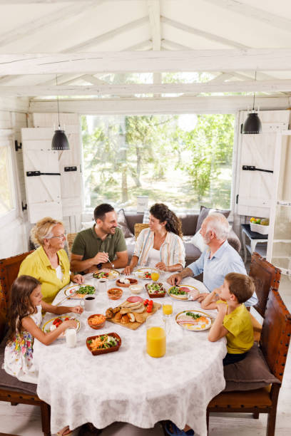 istock Happy extended family having a meal at dining table. 2159295902
