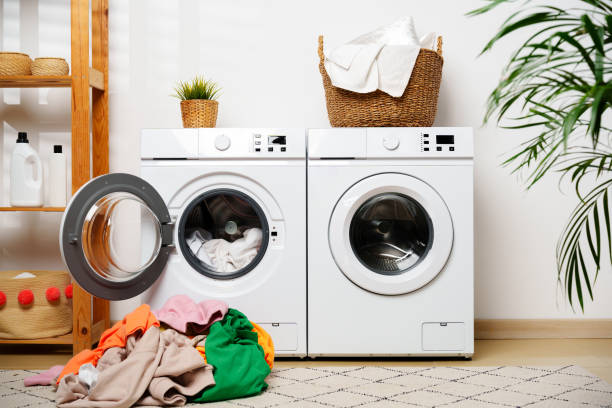 istock Laundry Day in a Modern Home With White Washers and a Wooden Shelf 2159296734