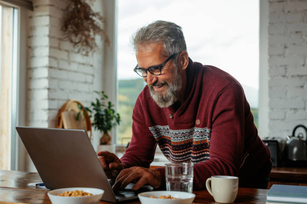 istock Cheerful mature man working at home 2159298118