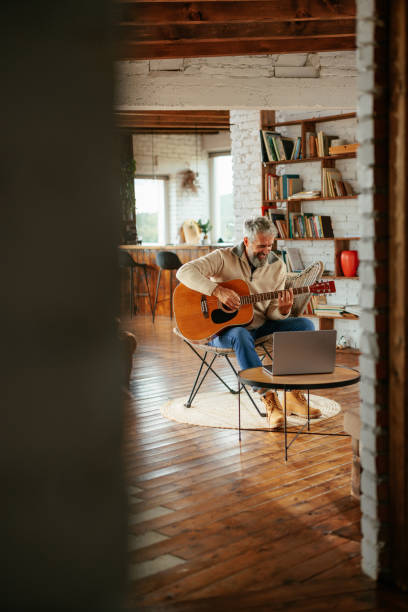 istock Senior man learning to play guitar 2159298145