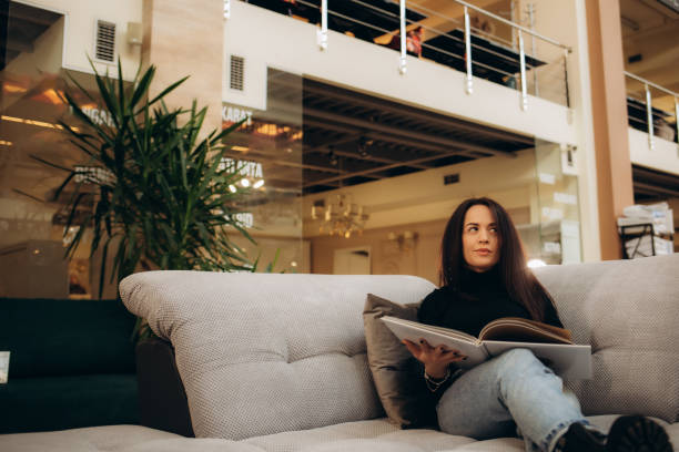 istock A woman looks through a catalog in a sofa store 2159298625
