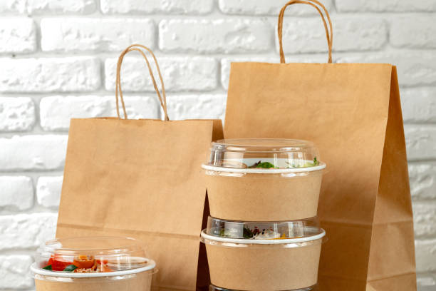 istock Take out food in boxes and craft bag against brick background 2159298698