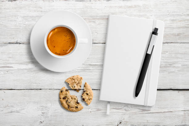 Mobile phone, cup of coffee with milk and notepad for writing notes. Work or relaxation