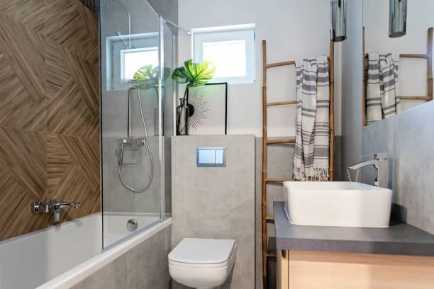 istock Home interior of modern bathroom with bat, ceramic bathroom sink and herringbone tile on the wall. Elegance and luxury in new apartment. 2159306301