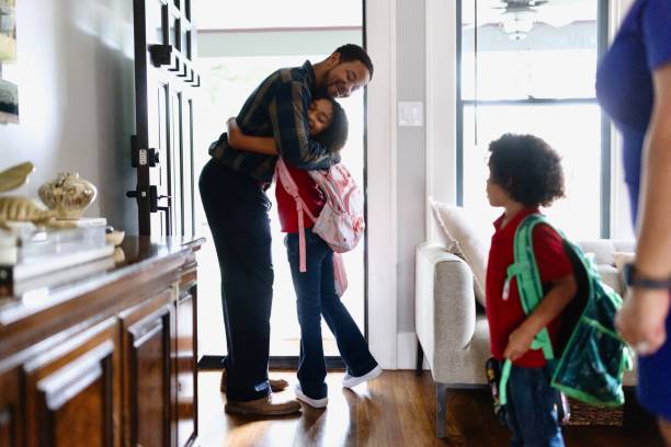 istock Father giving his daughter a goodbye hug before school 2159309431
