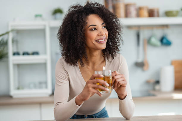 istock Beautiful woman drinking a tea in the kitchen at home. 2159309694