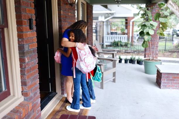 istock Mother hugging her daughter before school in the morning 2159309706