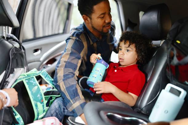 istock Father putting his son in a safety seat 2159309788