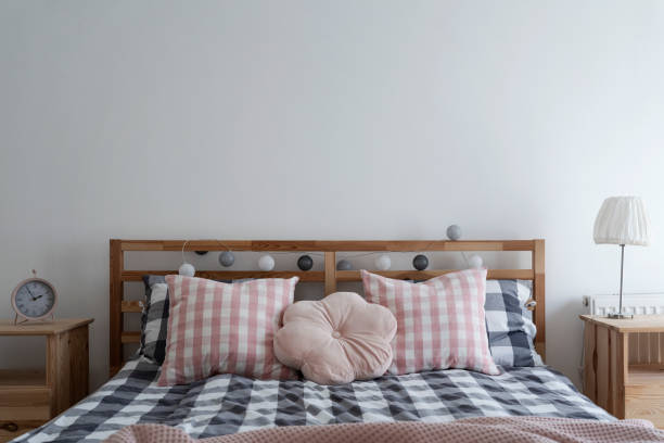 Modern bedroom with double bed. Home interior. Simplicity in architecture and decoration and design.