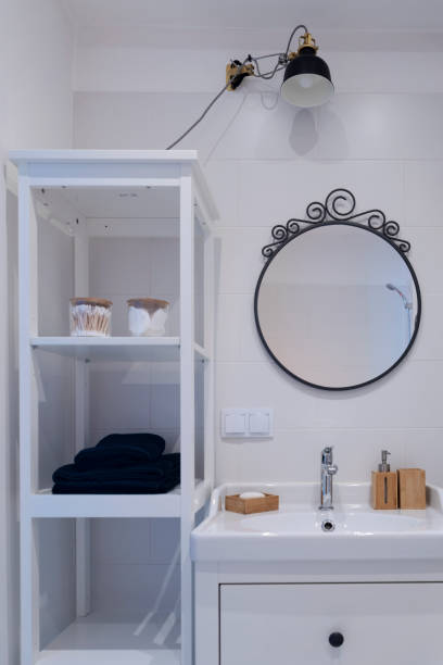 istock Home interior of bathroom with circle mirror and bathroom sink. 2159309954