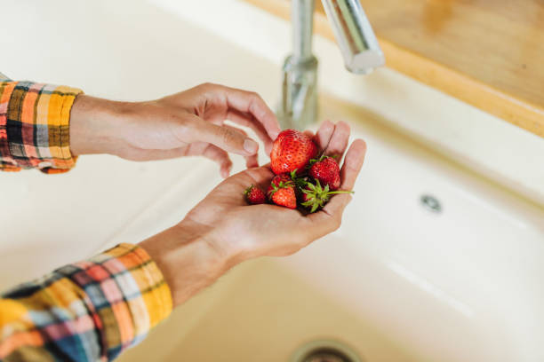 istock Washing strawberries in the kitchen 2159310560