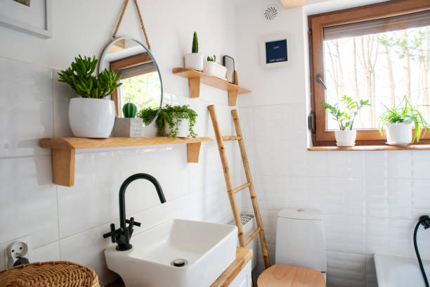 istock Home interior with ceramic bathroom sink and white tile on the wall with circle mirror. Rustic bathroom with window in indoors architecture and cosy design in cottage. 2159310664