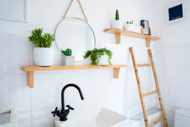 istock Home interior with ceramic bathroom sink and bowl and white tile on the wall with circle mirror. Rustic bathroom in indoors architecture and cosy design. 2159310671