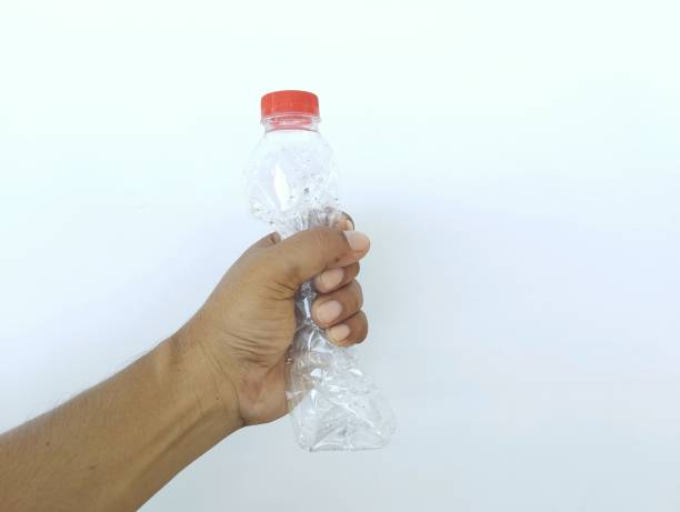 istock man hand holding a used plastic bottle isolated in white background 2159311218