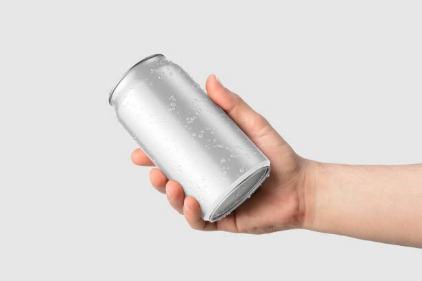 istock Aluminium drink can 330ml with water drops in a hand mockup template, isolated on light grey background. 2159311559