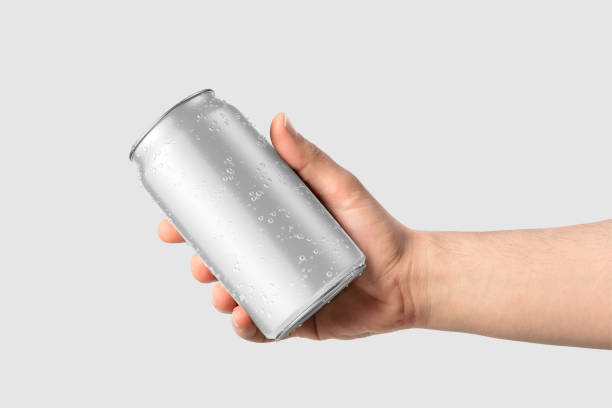 istock Aluminium drink can 330ml with water drops in a hand mockup template, isolated on light grey background. 2159311560