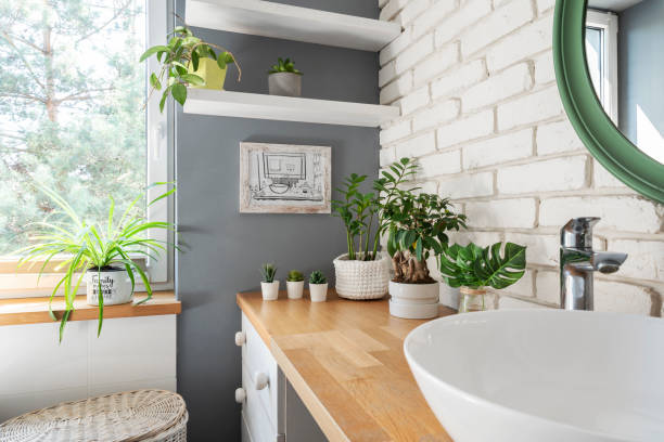 istock Home interior with ceramic bowl on countertop and brick wall. Modern bathroom in indoors architecture and modern design. Spa and houseplant with window. 2159311650
