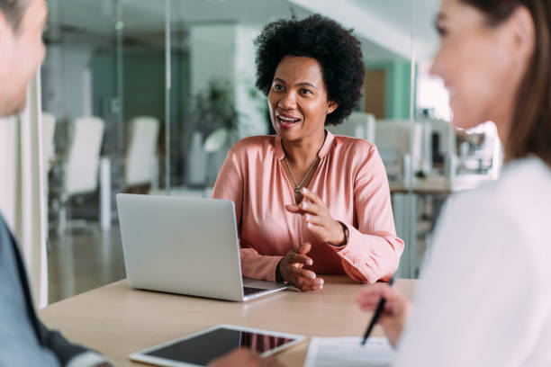 istock Group of business persons talking in the office. 2159311905