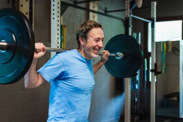 istock An active senior man is lifting a heavy weight bar in a gym 2159313045