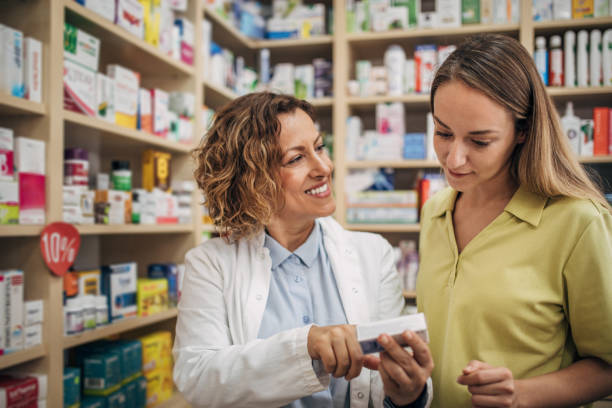 istock Pharmacist and young customer talking in the pharmacy 2159314968